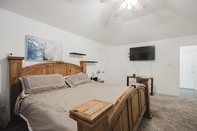 carpeted bedroom featuring lofted ceiling and a ceiling fan