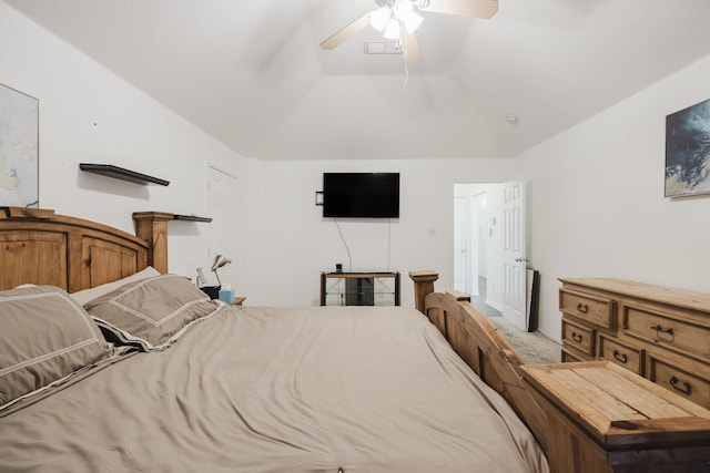 carpeted bedroom with ceiling fan, visible vents, and vaulted ceiling