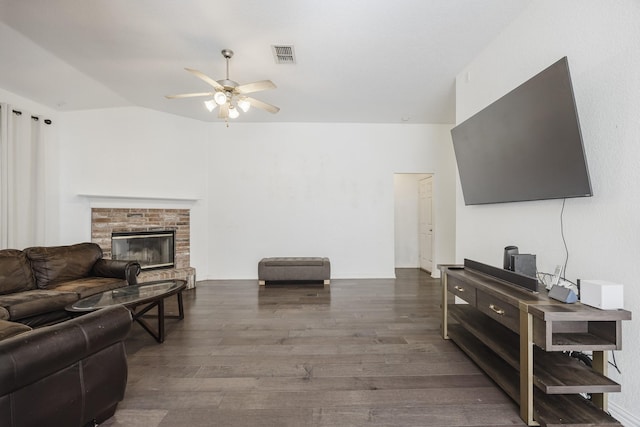 living room featuring ceiling fan, a fireplace, wood finished floors, and visible vents