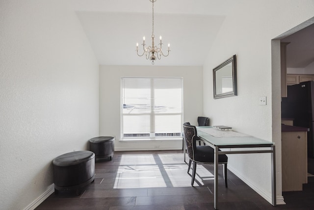 office space featuring lofted ceiling, an inviting chandelier, baseboards, and wood finished floors