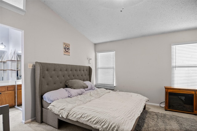 bedroom with lofted ceiling, multiple windows, and light colored carpet