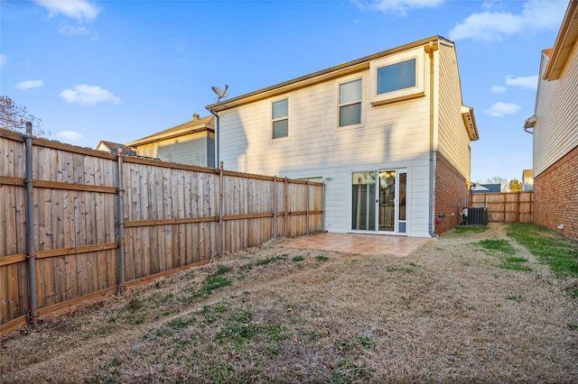 back of property featuring a patio area, a fenced backyard, and central AC