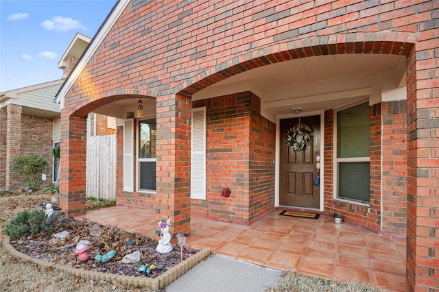 property entrance featuring brick siding