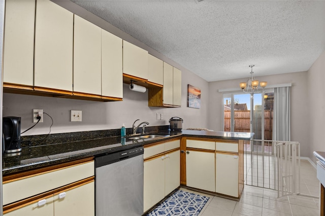 kitchen with a textured ceiling, light tile patterned flooring, a peninsula, a sink, and stainless steel dishwasher