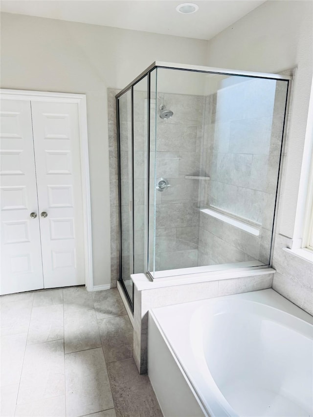 full bathroom featuring a stall shower and a bath