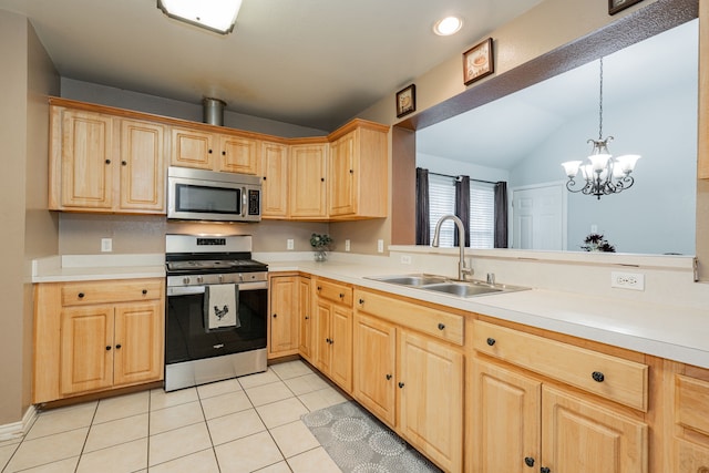 kitchen with stainless steel appliances, light countertops, light brown cabinets, and a sink