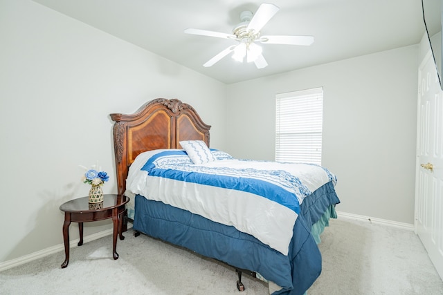 carpeted bedroom with a ceiling fan and baseboards