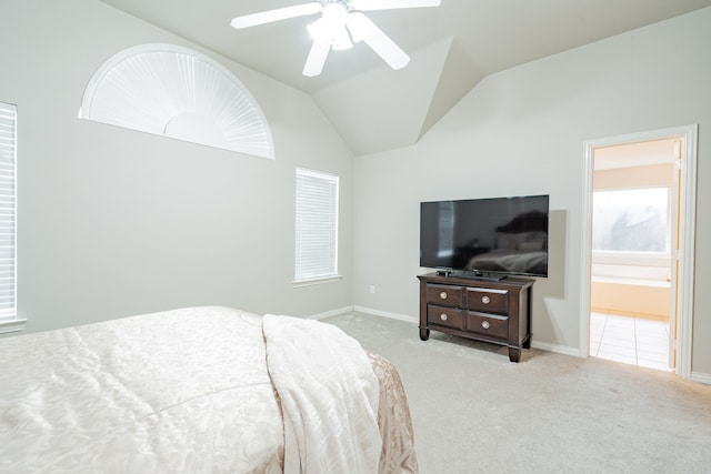 bedroom with lofted ceiling, carpet, a ceiling fan, and ensuite bathroom