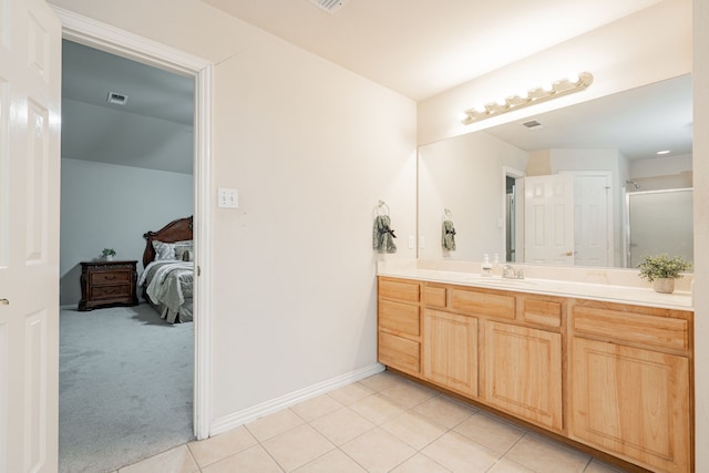 ensuite bathroom featuring baseboards, visible vents, tile patterned floors, ensuite bathroom, and vanity