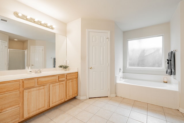 bathroom with visible vents, vanity, a shower stall, a bath, and tile patterned floors