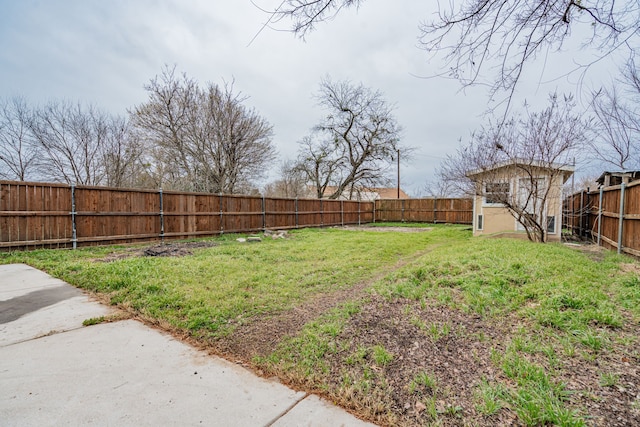 view of yard with a fenced backyard, an outdoor structure, and a shed