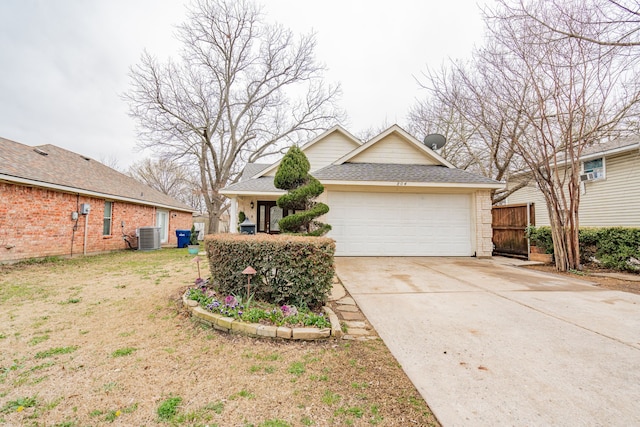 view of front of house featuring driveway, an attached garage, a shingled roof, and cooling unit