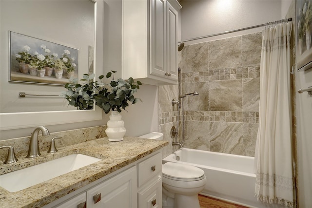 bathroom with shower / bathtub combination with curtain, toilet, and vanity