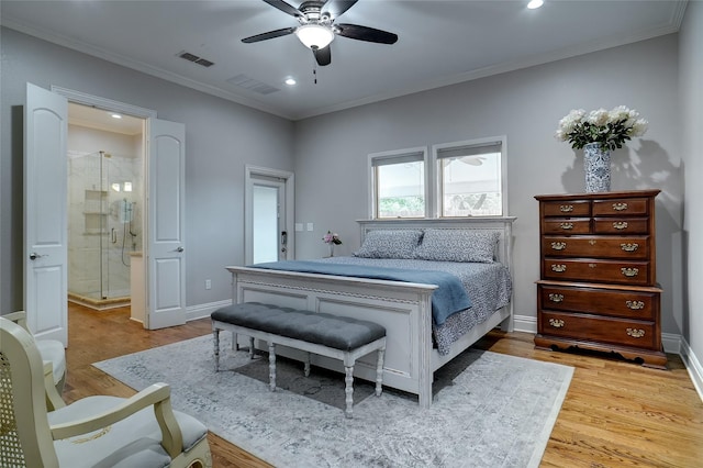 bedroom featuring ornamental molding, visible vents, baseboards, and wood finished floors