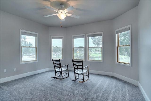 interior space featuring plenty of natural light, a ceiling fan, and baseboards