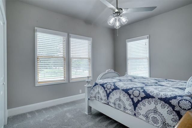 carpeted bedroom featuring ceiling fan and baseboards