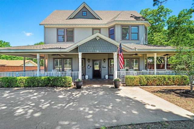 view of front of house featuring ceiling fan, fence, and a porch