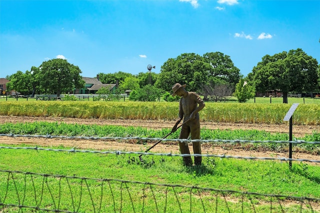 view of yard with a rural view and fence