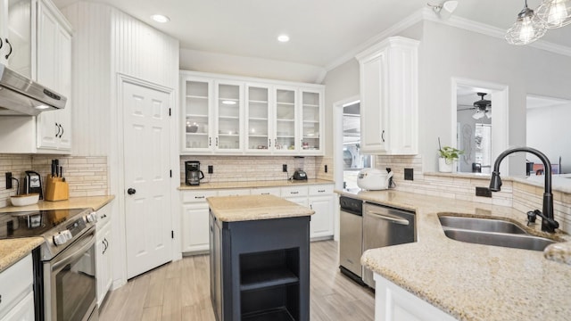 kitchen with ornamental molding, a ceiling fan, a sink, white cabinetry, and stainless steel appliances