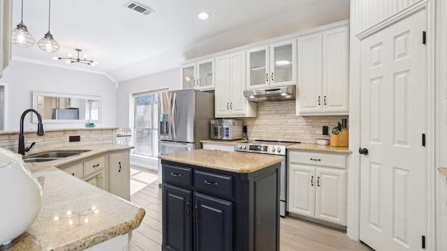 14017 NW Ct, Haslet, TX 76052 - kitchen with stainless steel electric stove, a center island, under cabinet range hood, white cabinets, and backsplash