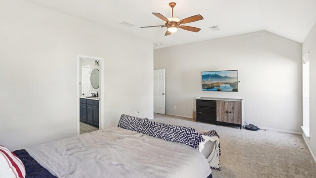 bedroom with connected bathroom, baseboards, ceiling fan, light colored carpet, and vaulted ceiling