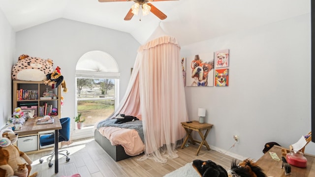 bedroom with wood finish floors, ceiling fan, baseboards, and lofted ceiling