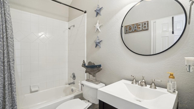 full bathroom with toilet, shower / bath combo, vanity, and a textured wall