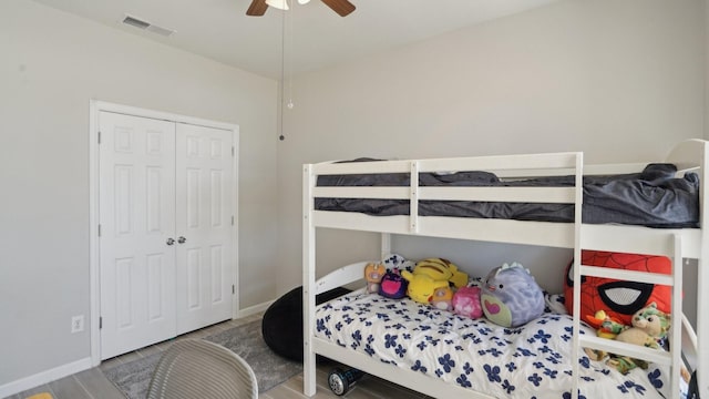 bedroom with a ceiling fan, visible vents, a closet, and baseboards