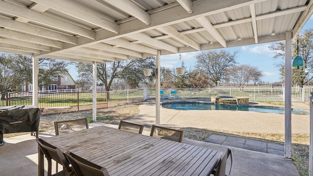 view of patio with outdoor dining space, area for grilling, and a fenced backyard