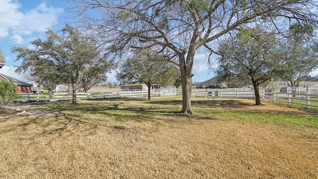 view of yard featuring an outdoor structure and fence