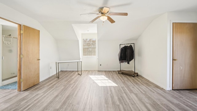 bonus room featuring light wood-type flooring, lofted ceiling, baseboards, and ceiling fan