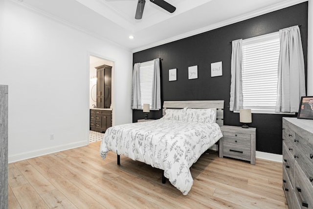 bedroom with baseboards, a raised ceiling, crown molding, light wood-style floors, and recessed lighting