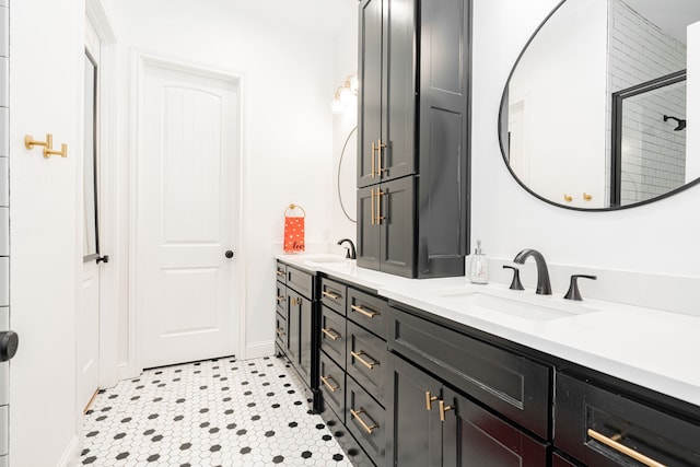 bathroom with double vanity, baseboards, and a sink