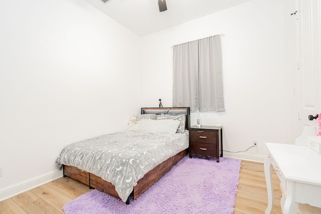 bedroom featuring a ceiling fan, baseboards, and wood finished floors