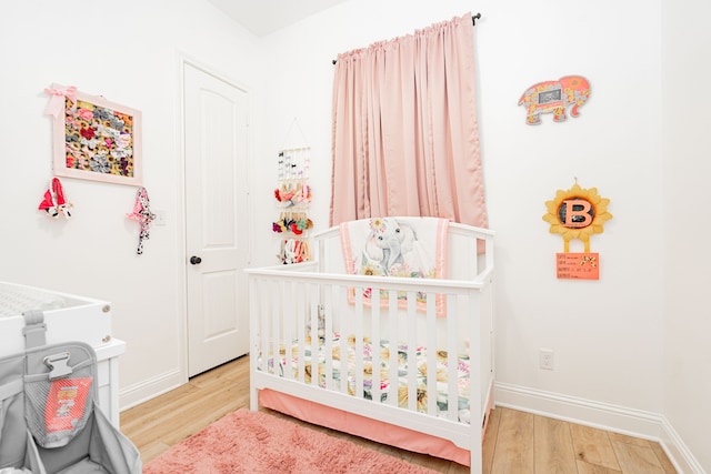 bedroom with wood finished floors and baseboards