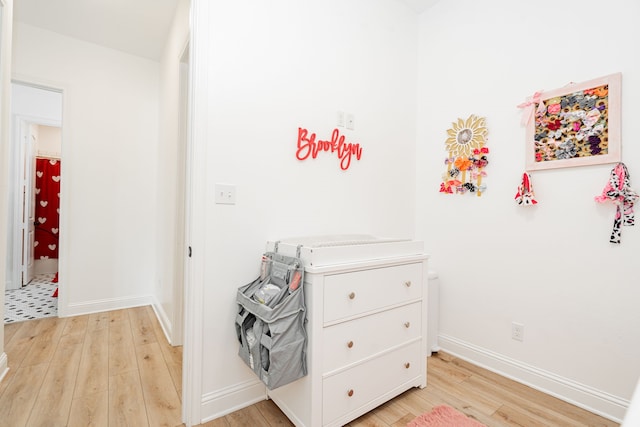 bedroom with light wood-style flooring and baseboards