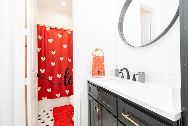 full bathroom featuring toilet, shower / tub combo with curtain, and vanity