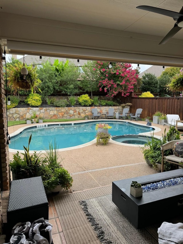 view of pool featuring a fenced in pool, a fenced backyard, a patio, and an in ground hot tub