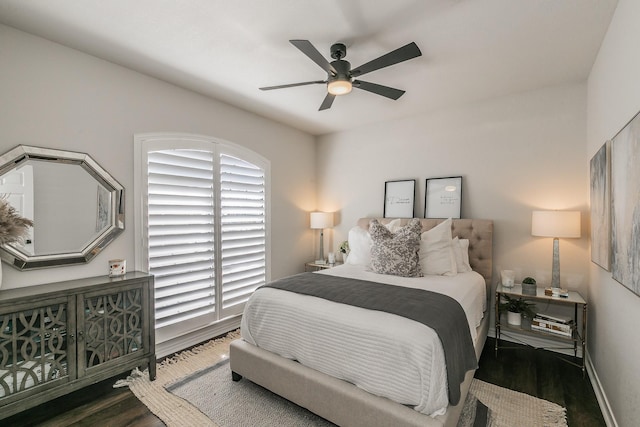 bedroom with baseboards, ceiling fan, and wood finished floors