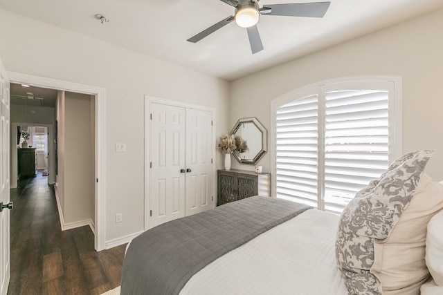 bedroom featuring a closet, ceiling fan, baseboards, and wood finished floors