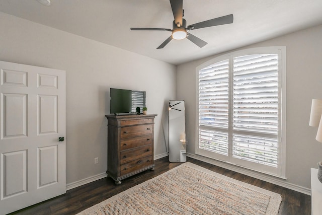 bedroom featuring a ceiling fan, dark wood-style floors, and baseboards