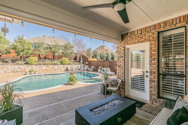 view of pool featuring a fenced in pool, a fire pit, a fenced backyard, a patio area, and an in ground hot tub