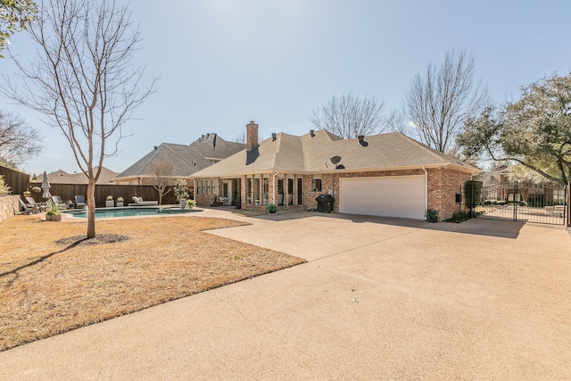 view of front of home with brick siding, a fenced in pool, a garage, driveway, and a gate