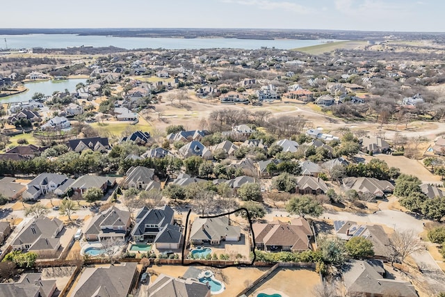 drone / aerial view featuring a residential view and a water view