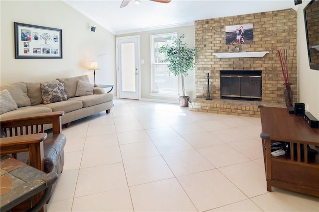 tiled living room with crown molding, a brick fireplace, vaulted ceiling, and ceiling fan