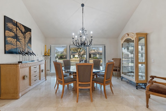 dining space with high vaulted ceiling and a notable chandelier