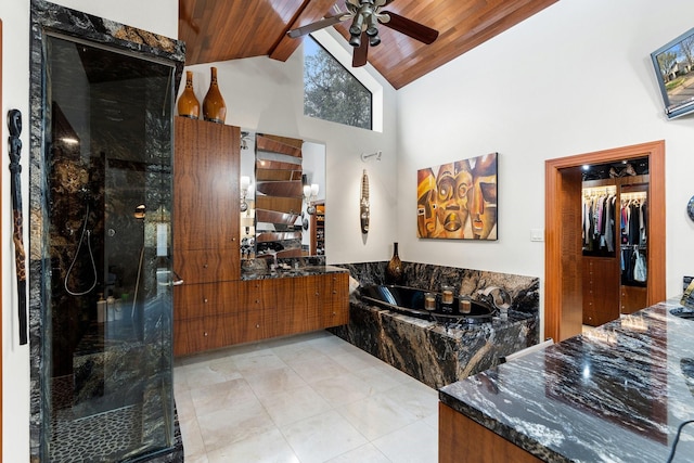 bathroom featuring beam ceiling, a garden tub, a marble finish shower, wood ceiling, and vanity