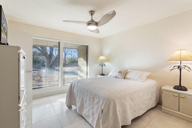 bedroom with a ceiling fan and light tile patterned floors