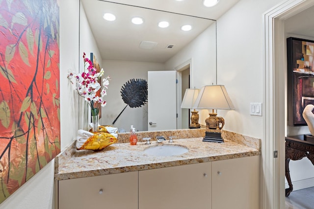 bathroom with recessed lighting, visible vents, and vanity