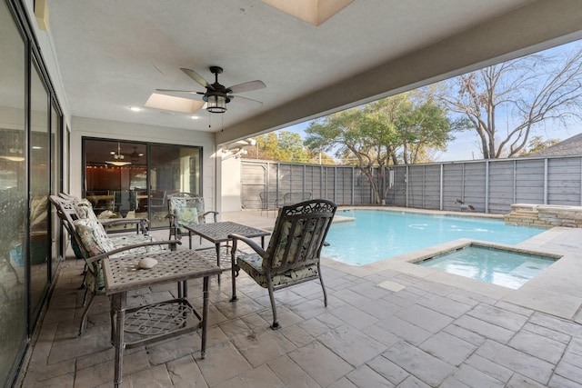 view of swimming pool featuring a fenced in pool, a patio, ceiling fan, a fenced backyard, and an in ground hot tub